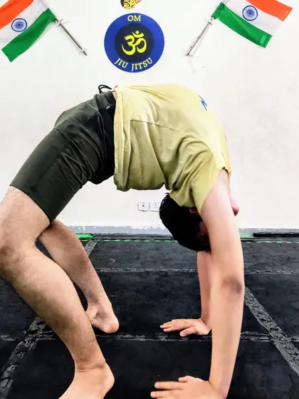 Yoga se hi hoga. Another student shows his flexibility with a deep wheel pose, highlighting our commitment to holistic training that includes yoga for recovery and mobility.