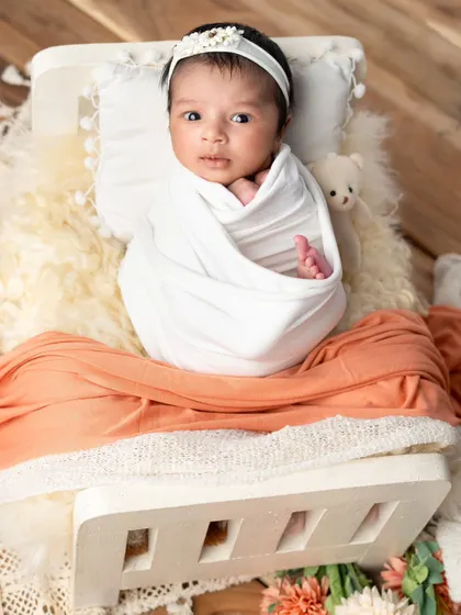 Look at those tiny eyes peeking out. This is one of those special moments when a newborn is calm and awake, allowing us to capture their curious gaze.