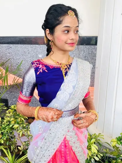 A close-up of the half-saree lehenga, showing the embroidery on the blouse and the texture of the dhavani.