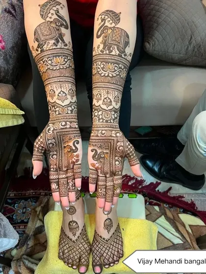 A complete bridal look with intricate elephant designs on both the hands and matching patterns on the feet.