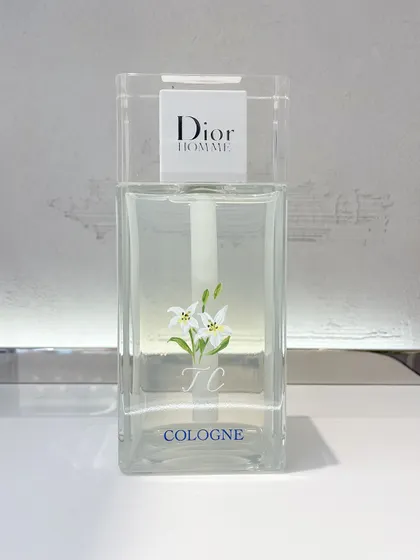"White is pure and simple and matched with everything." - Christian Dior. Here, I painted dainty white lilies on a Dior Homme Cologne bottle, combining it with engraved initials for a client onsite.