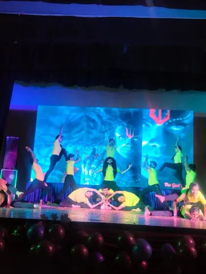 A complex and artistic group asana performed by my students on stage. This is the result of months of dedicated practice and discipline.