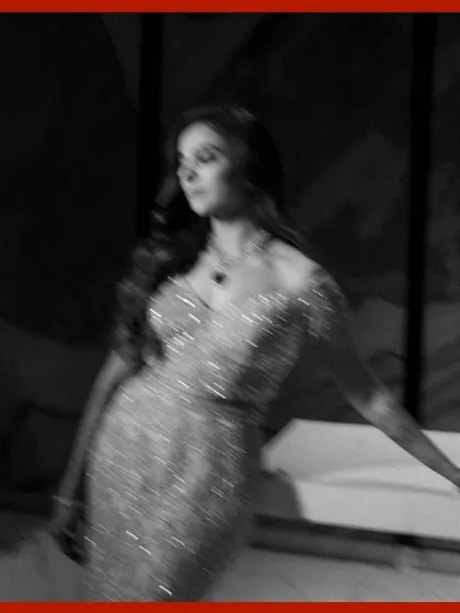 An artistic, motion-blur portrait of the bride. This black and white shot captures a sense of movement and dreaminess, focusing on the texture of her sparkling gown.