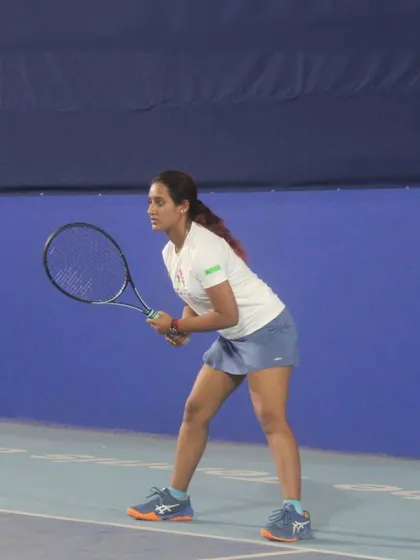 In the ready position, anticipating the next shot. This photo highlights the mental focus and preparation that are just as crucial as physical skill in a tennis match.