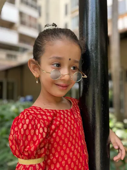Leaning in with a gentle smile. This photo captures the sweet and expressive nature of our young students.