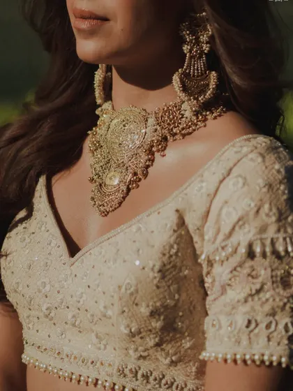 A close-up on the details of Sheena's jewelry and the soft shimmer on her collarbones. A body glow is the perfect finishing touch for a bridal look.