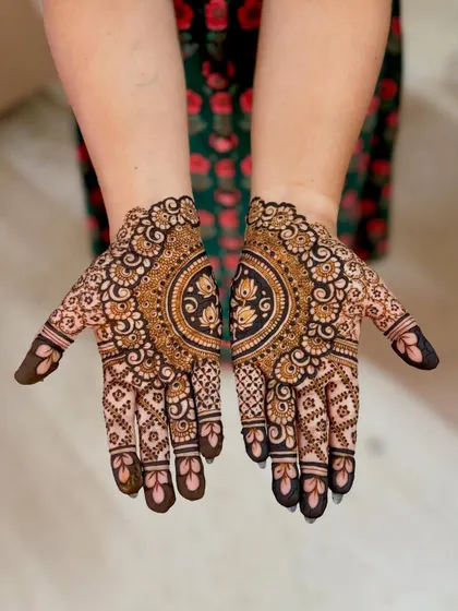 A beautiful design with a central half-mandala featuring a lotus, surrounded by dense floral work.