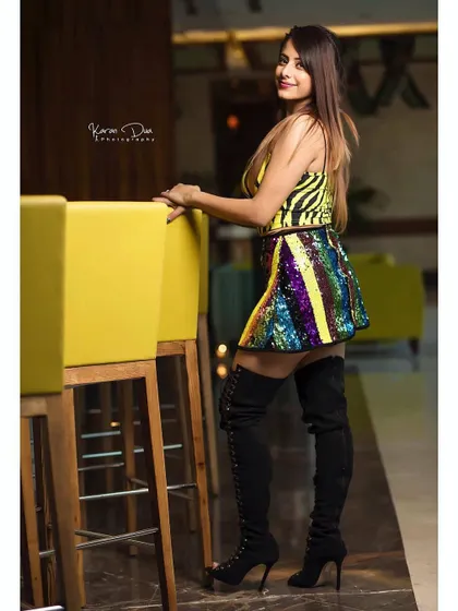 Confidence is key for a look like this. The makeup features a strong eye and contoured cheeks, designed to complement the thigh-high boots and sequined skirt for a cohesive, high-fashion statement. This is perfect for a birthday party or a special celebration.