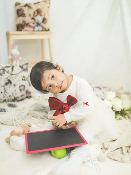 What a cutie! A simple, candid moment during a toddler session, where her personality just shines through.
