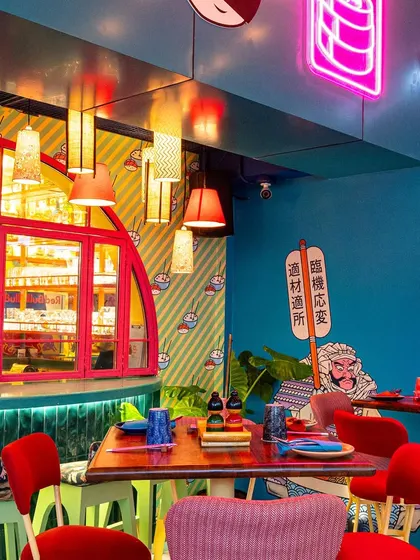 This corner at The Fatty Bao combines neon signs, patterned wallpaper, and unique light fixtures. My job is to compose these eclectic elements into a single, balanced image that captures the brand's essence.