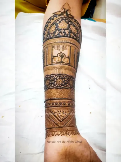 A full-arm bridal design without any human figures. This piece focuses on the beauty of swans and peacocks set within intricate architectural dome patterns.