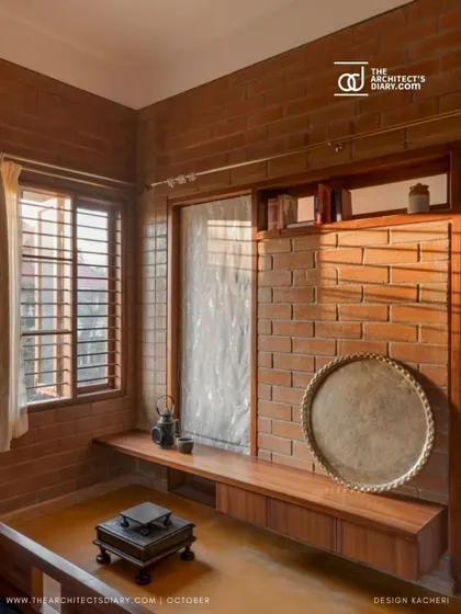 A quiet corner with a built-in wooden bench, showcasing the simple beauty of exposed brick and the way sunlight interacts with the space.