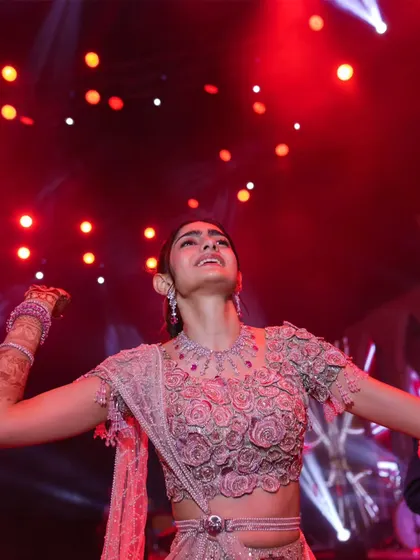 The bride, lost in the music under the vibrant red stage lights. These are the candid moments of pure bliss that I love to see, a sign of a truly successful celebration.