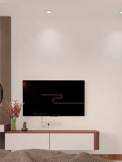 The TV and dressing unit in the 'Dusty Rose' room, featuring a fluted panel and a backlit circular mirror.