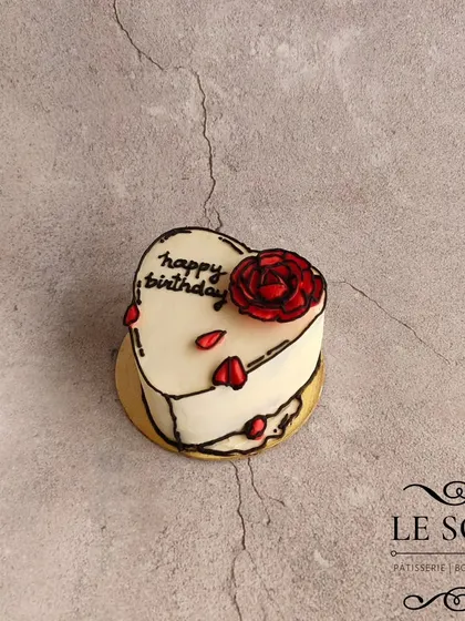 This tiny bento-sized heart cake is a miniature version of my popular comic-style design. It's a Chocolate Truffle cake, hand-carved and decorated with a buttercream rose.
