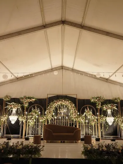 The full stage setup within the reception tent, showing the interplay of light and shadow that creates a moody and romantic atmosphere.