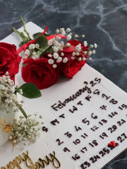 The detail of the hand-piped calendar on this unique anniversary cake.