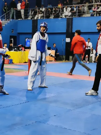 In the ring, ensuring a fair and disciplined match. My experience as a referee helps me train my students to compete with integrity.
