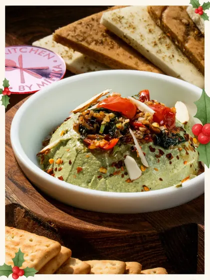 This beautiful green dip, topped with red tomatoes and white almonds, perfectly captures the colours of Christmas and adds a gourmet touch to your celebration.