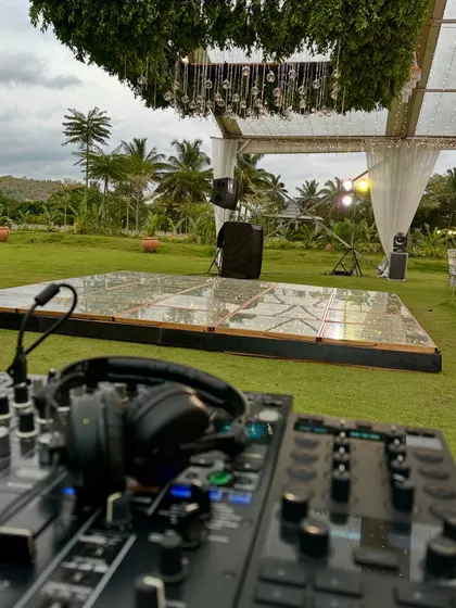 The calm before the party. Here’s my professional DJ setup overlooking a beautiful outdoor dance floor, all set for a wedding reception and afterparty. I handle all the technical details so you can focus on celebrating.