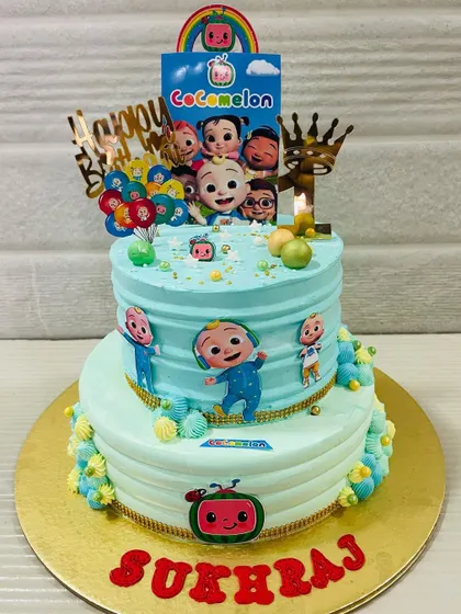 A full view of the impressive Cocomelon cake, perfect for a big first birthday party.