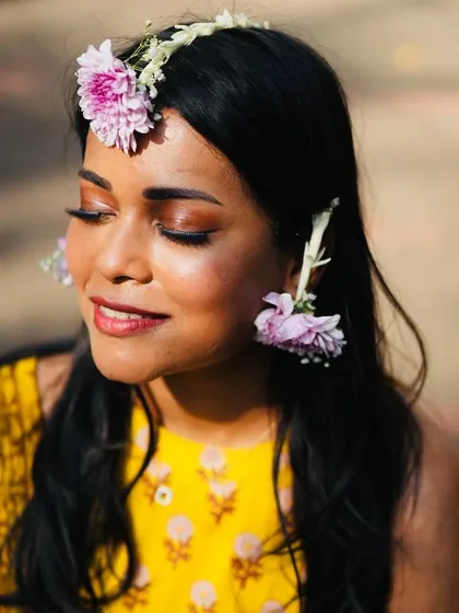 A portrait of the bride, radiant in her yellow outfit and custom purple floral jewelry. I coordinate with vendors to ensure every detail, from flowers to accessories, is perfectly harmonized.