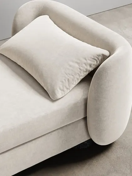 A close-up of the Divan's curvaceous form and its easeful bouclé fabric. The modern union of comfort and elegance makes you feel drawn into its motherly embrace.