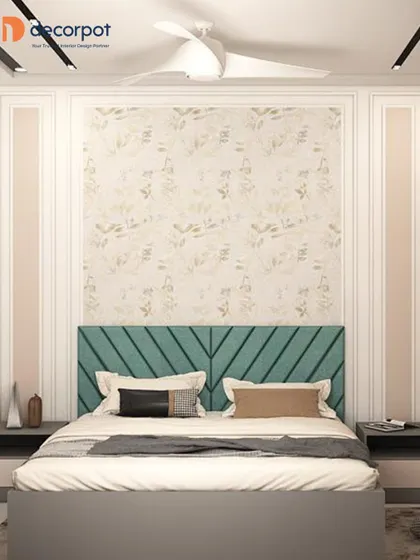 A soft and elegant bedroom with a teal, diagonally-tufted headboard. The wall features classic moulding and a subtle floral wallpaper, creating a sophisticated and timeless look.