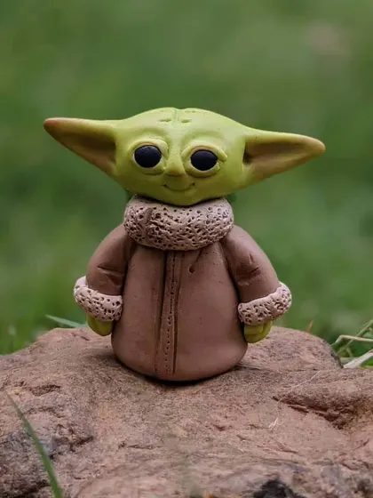 A Jedi Master in miniature form. This Baby Yoda sculpture is a perfect gift for any Star Wars fan.