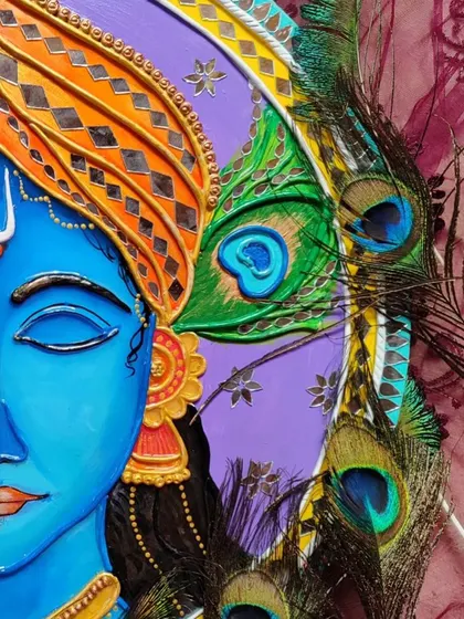 A close-up of the Krishna Lippan art, showing the texture of the clay work on his turban and the real peacock feathers I incorporated into the design for an authentic touch.