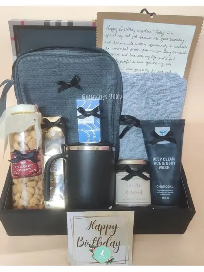 This birthday hamper is all about comfort and care. It features a travel pouch, deep clean face wash, a scented candle, a thermal mug, and a handwritten letter to add that personal touch.