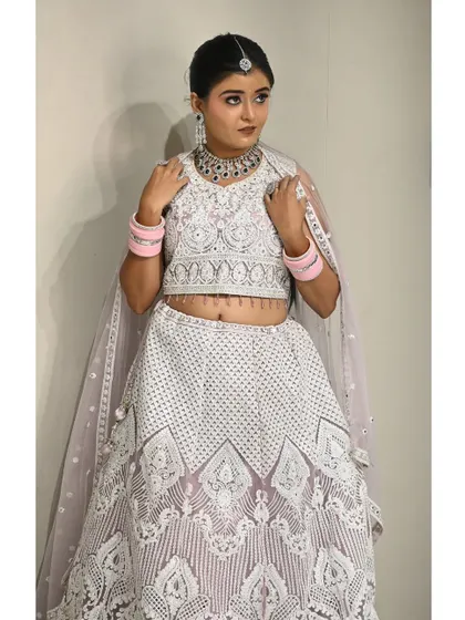 A complete look featuring the white rental lehenga. The sleeveless blouse and lightweight skirt make it comfortable to wear for long hours.
