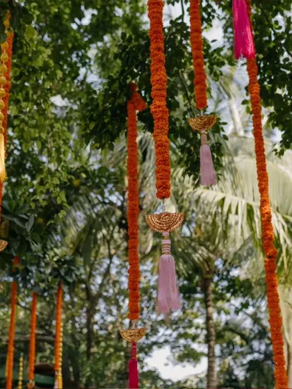 A close-up of the colorful tassels and marigold strings hanging from the trees.