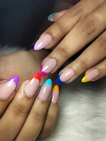 Why stick to one color? This playful design puts a colorful twist on the classic French manicure, with each nail tip painted in a different vibrant shade.