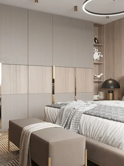 A luxurious wardrobe design with fluted panels and metallic gold accents. The integrated shelving next to the bed provides both storage and a display area, blending seamlessly with the room's elegant decor.