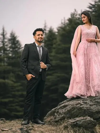 A dramatic pose with the woman standing on a rock in her flowing gown, creating a powerful and elegant image in the heart of the forest.