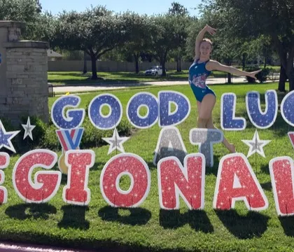 Our Level 9 gymnast, Addy, posing with the "Good Luck" sign before her final meet of the season.