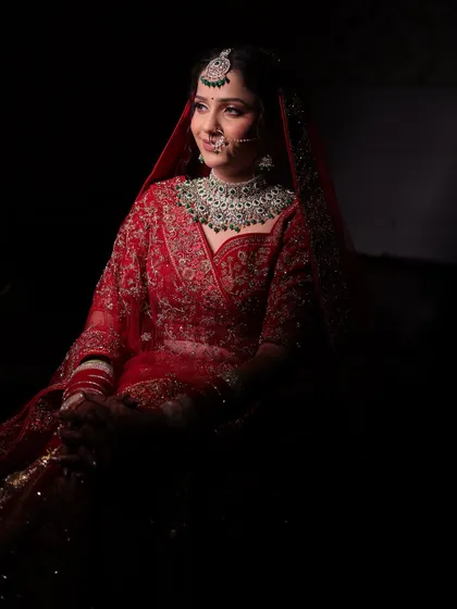 Urvashi's subtle and natural bridal look. We focused on soft, shimmery eyes and flawless skin to complement her gorgeous red lehenga and emerald jewellery.