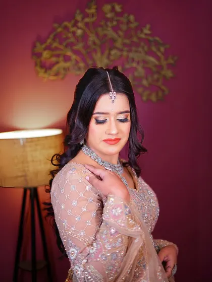 A portrait in the pastel peplum lehenga, showing a bold and beautiful makeup look.