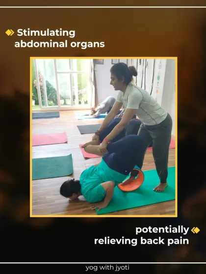 I am assisting a young student with Locust Pose on a yoga wheel. This support helps stimulate abdominal organs and can relieve back pain.