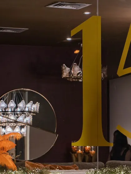 A creative use of branding, with large "15" lettering integrated into the decor, visible through a modern, circular mirror.