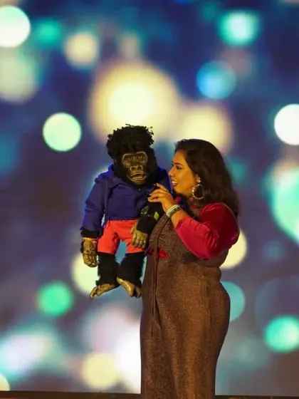 This is what pure joy looks like. On stage with Nikki, microphone in hand, sharing a laugh with the audience. This is my happy place, and I love making it yours too, whether it's for a corporate event or a college show.