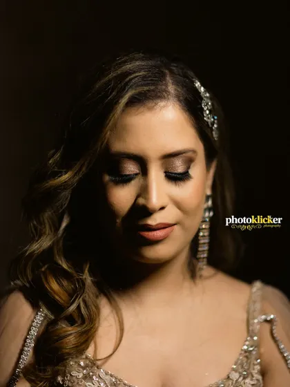 A close-up portrait of the bride-to-be, highlighting her glamorous makeup and elegant hair accessory for the engagement party.