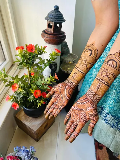 The back of the hands for the engagement bridal, featuring a simple yet beautiful design that extends up the arm.