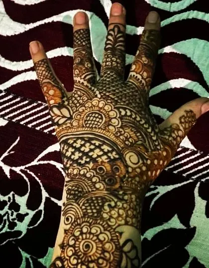 A full palm design showcasing a variety of traditional filler patterns, creating a rich and complex look.