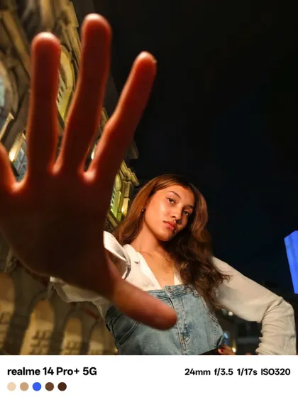 A wide angle portrait taken from a low perspective. This creative angle makes the scene feel more dramatic and immersive, capturing both the subject and the grand architecture behind her.