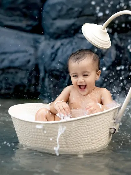 A big laugh and a big splash! This little boy is having the best time in his boat in our custom-built pond.