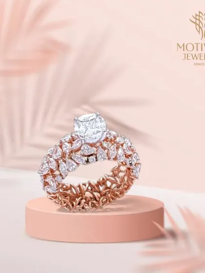 An opulent creation in rose gold, this ring features a central solitaire perched atop a wide band of intricate, leaf-like diamond clusters. It is a true masterpiece of craftsmanship.