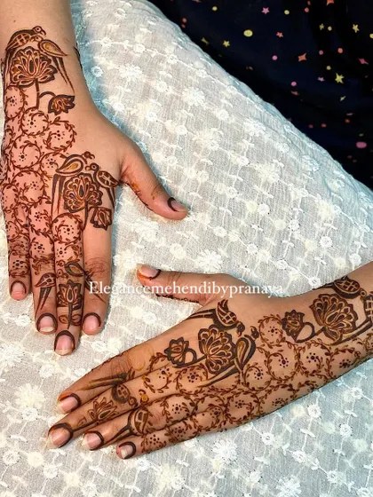 A minimal backhand design with parrots and floral vines, created by my talented team.