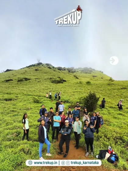 A group photo on the rolling green hills of the Bandaje trek. Every step is worth it for views and company like this.
